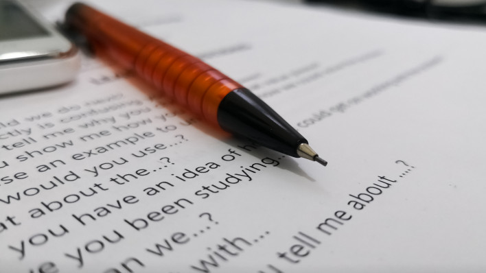 close up of agreement with pen