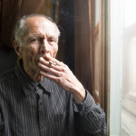 elderly man smoking a cigarette