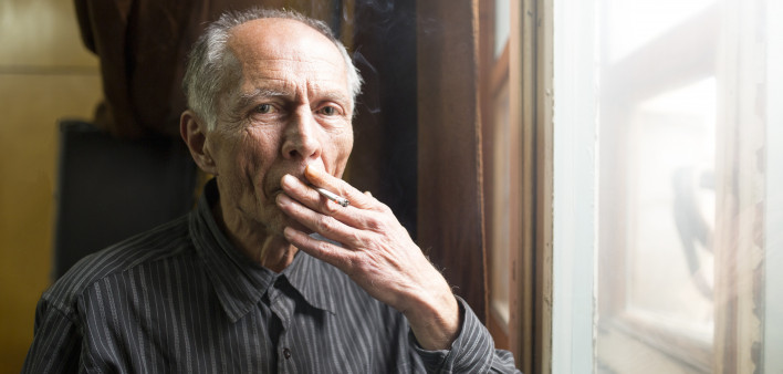 elderly man smoking a cigarette
