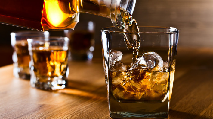 whiskey and natural ice on old wooden table