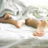in bed sleeping feet showing