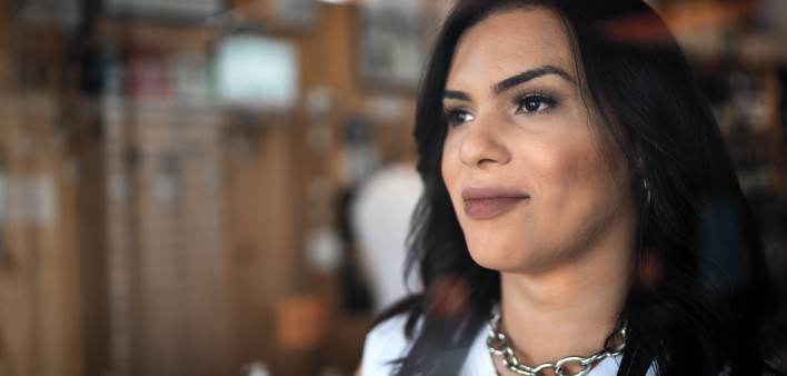 Transgender female looking through window