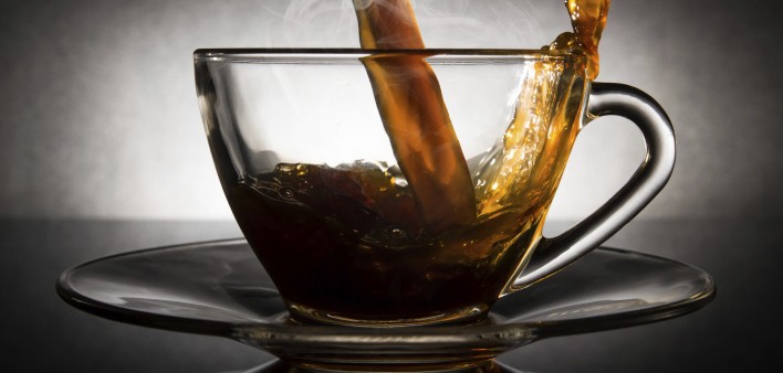 coffee pouring into a clear glass cup