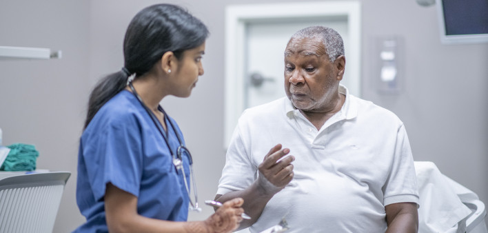 nurse talking to black doctor