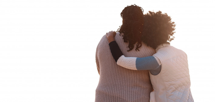 two woman embrace