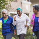 Three senior black women exercising together