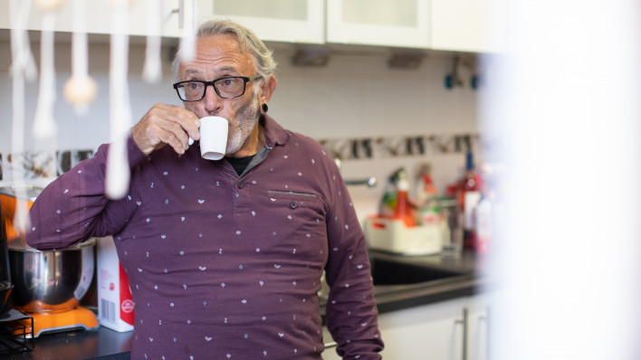 Portugal A healthy senior man living with HIV drinking coffee
