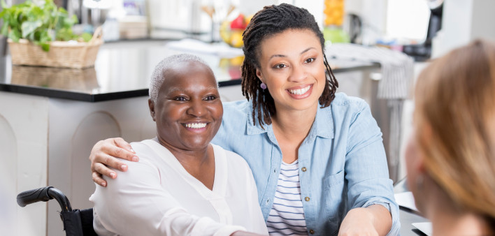 mother daughter talking to doctor smiling