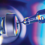 needle going into vial vaccine