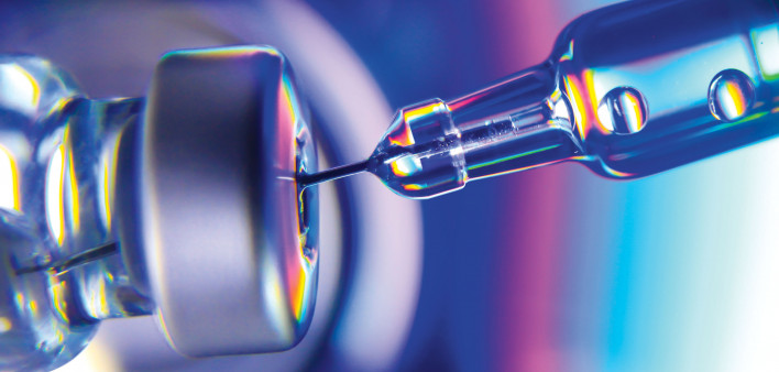needle going into vial vaccine