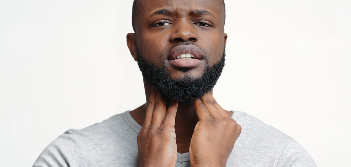 man holding throat thyroid black man