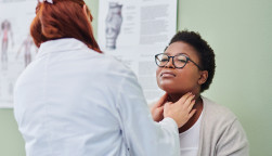 black woman getting thyroid exam