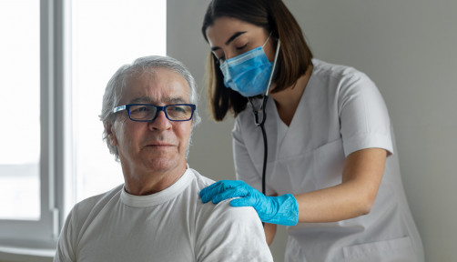 nurse and male pateint listening to lungs