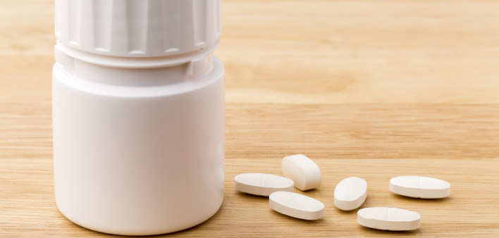 white pills and pill bottle medication generic image