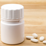 white pills and pill bottle medication generic image