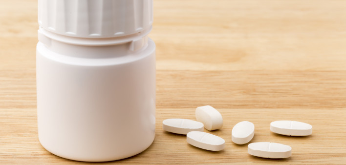 white pills and pill bottle medication generic image