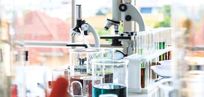 beakers and microscopes in laboratory