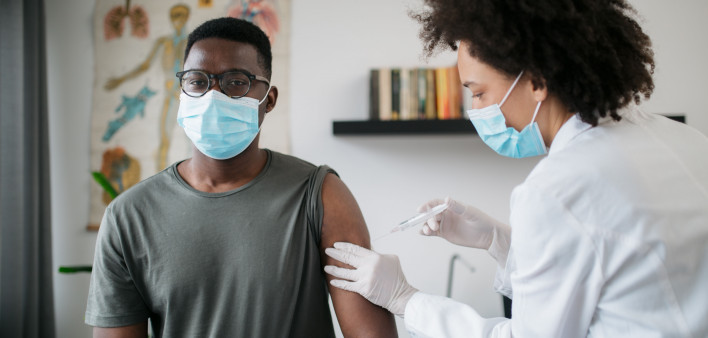 black patient man getting vaccine face mask covid coronavirus