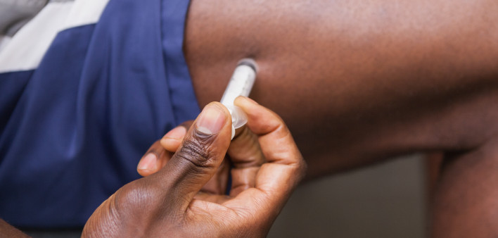 Close up of muscular man injecting steroids in the gym testosterone