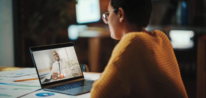 Multiethnic Latina Manager is Making Video Call to His Doctor on Laptop