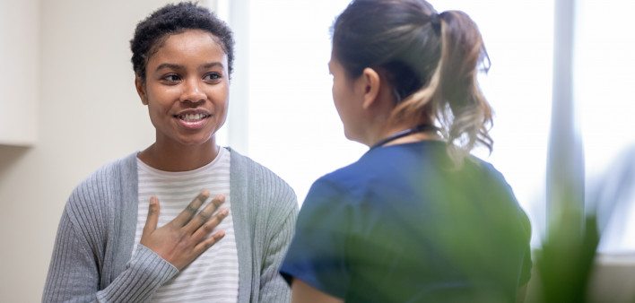 young woman taking to her doctor