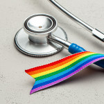 Stethoscope and LGBT rainbow ribbon pride tape symbol. Medical support after sex reassignment surgery.