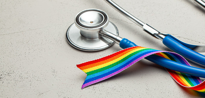 Stethoscope and LGBT rainbow ribbon pride tape symbol. Medical support after sex reassignment surgery.