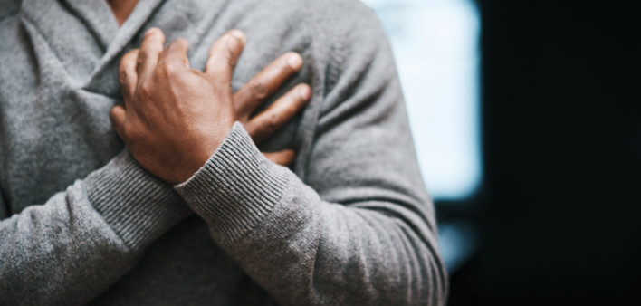 African American Man holding chest pain heart