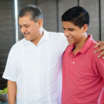 latino family having a barbecue grilling