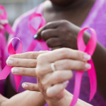 Multi-ethnic women with breast cancer awareness ribbons