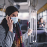 Young Woman With Face Mask Talking On The Phone