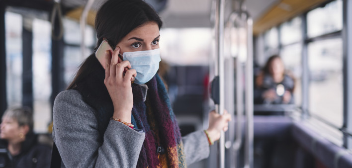 Young Woman With Face Mask Talking On The Phone