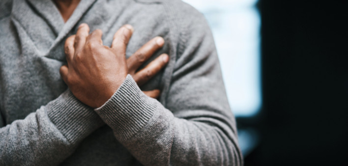 African American Man holding chest pain heart