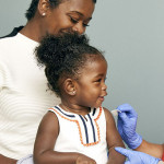 little girl and mother vaccine