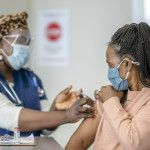 A senior female is receiving her COVID-19 vaccine