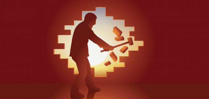 Escape concept with a man who regains freedom by breaking a wall.