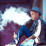 well dressed teen vaping e cigarette
