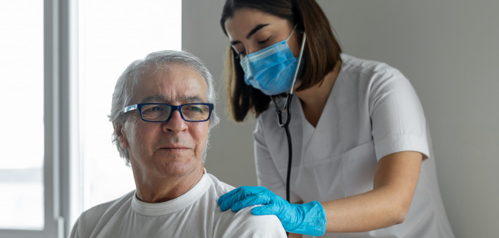 nurse and male pateint listening to lungs