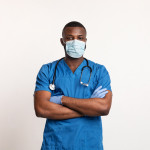 Confident black doctor in face mask and gloves