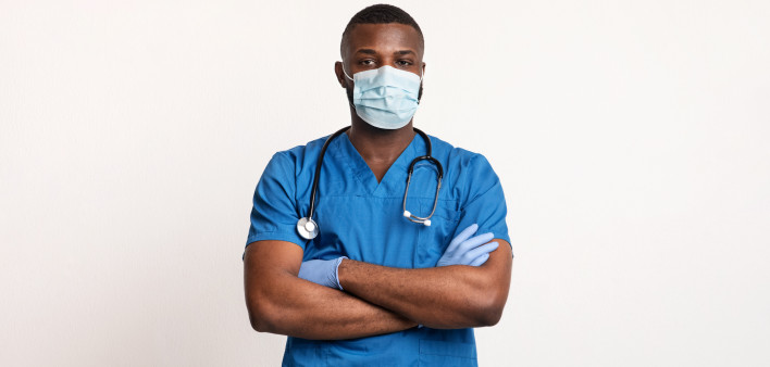 Confident black doctor in face mask and gloves