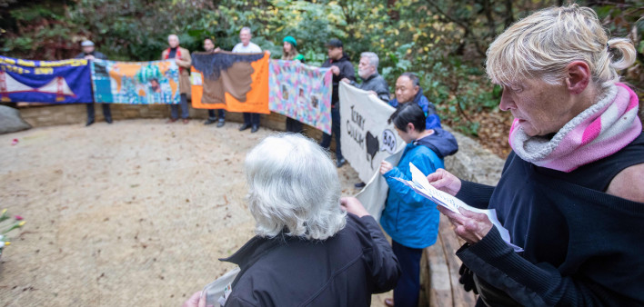 Gert McMullin, mother of the AIDS Memorial Quilt, leads a community reading of names in the Circle of Friends at the National AIDS Memorial Grove on World AIDS Day.  The names being read are newly engraved this year within the memorial and also of newly c
