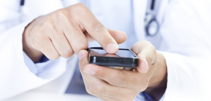  a doctor touching a smart phone