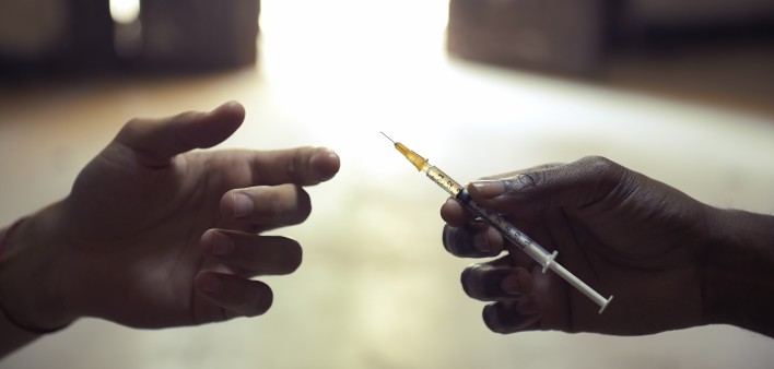 drug users passing a syringe