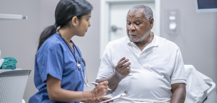 nurse talking to black doctor
