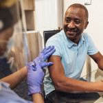 black man getting coronavirus vaccine
