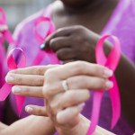 Multi-ethnic women with breast cancer awareness ribbons
