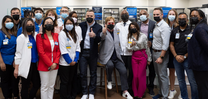 Elton John and David Furnish, center, join Walmart staff to launch more HIV-focused Specialty Pharmacies of the Community.