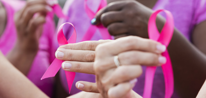 Multi-ethnic women with breast cancer awareness ribbons
