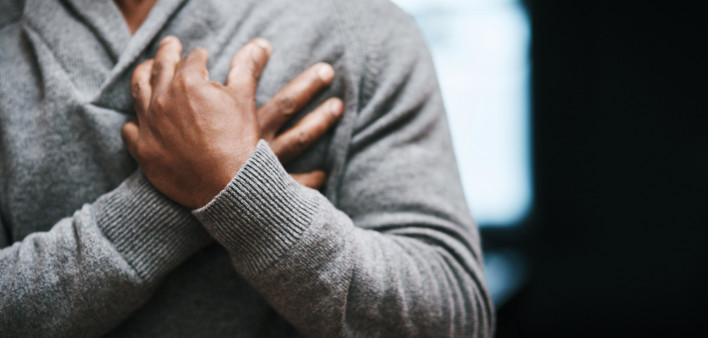 African American Man holding chest pain heart