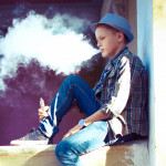 well dressed teen vaping e cigarette